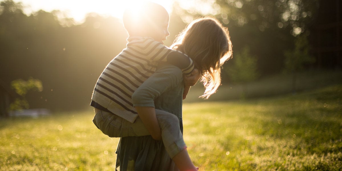 child being carried on back