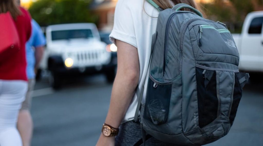 woman with gym bag backpack