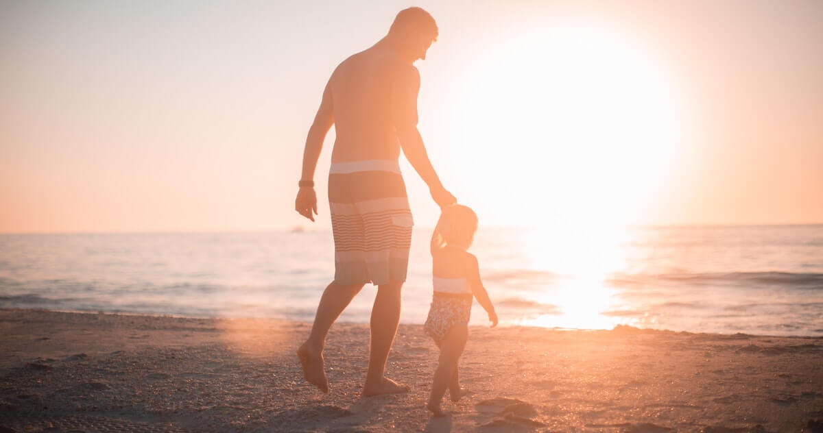 dad with little girl on a beach